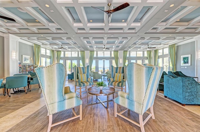 sunroom with ceiling fan and coffered ceiling