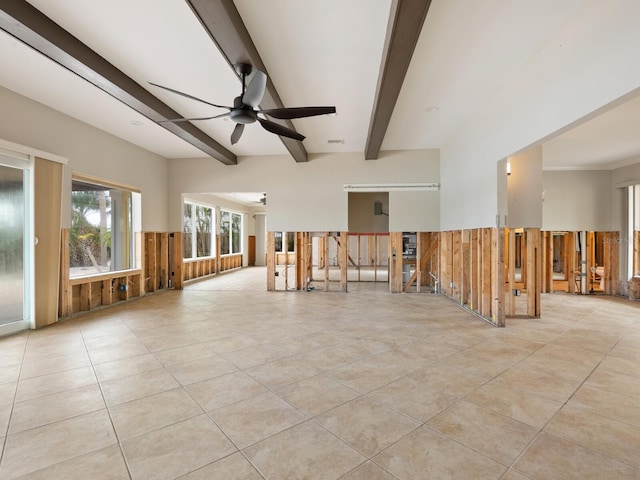 empty room with beamed ceiling, ceiling fan, and light tile patterned flooring