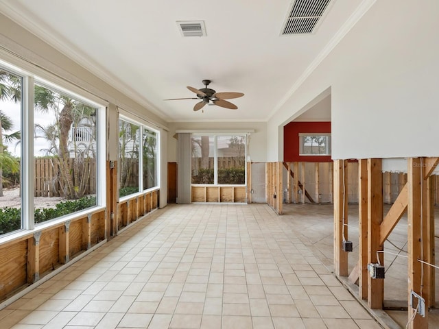 unfurnished sunroom featuring ceiling fan