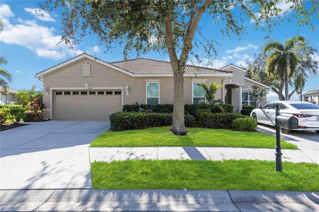 view of front of property with a garage and a front lawn