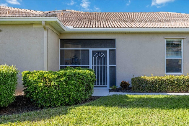 property entrance with a yard