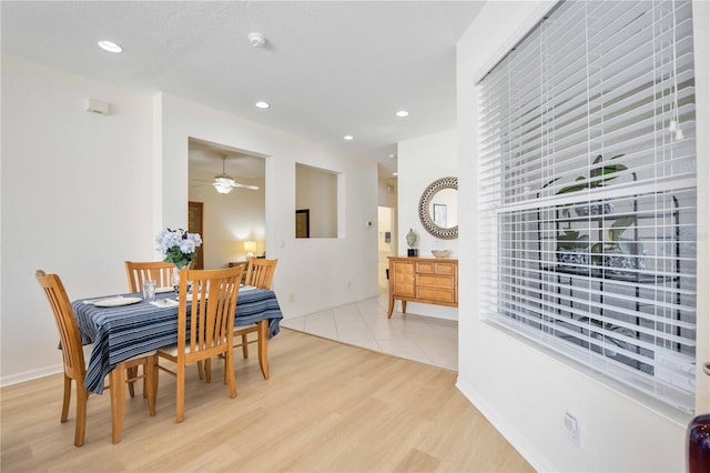 dining area with ceiling fan and light hardwood / wood-style flooring