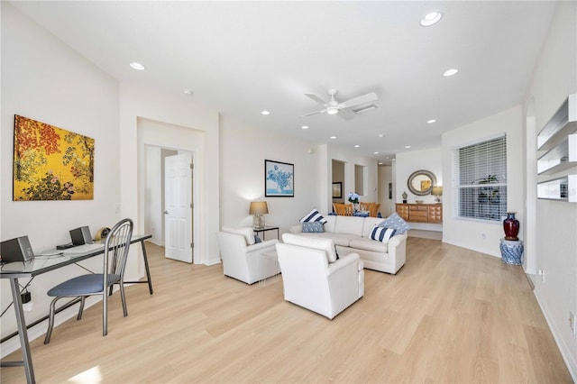 living room with ceiling fan and light hardwood / wood-style flooring