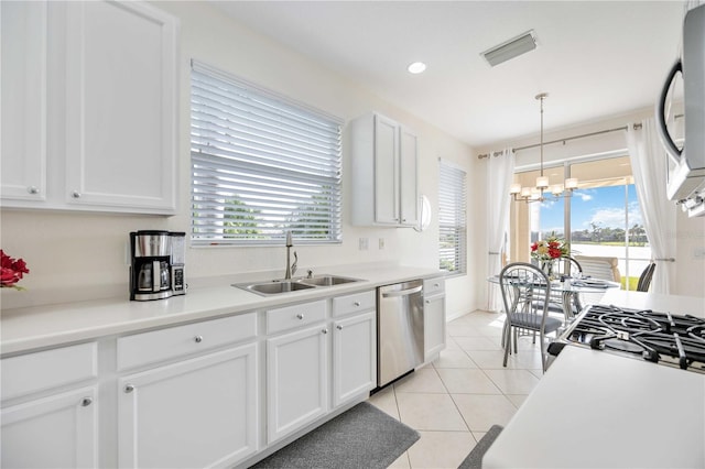 kitchen featuring sink, hanging light fixtures, a notable chandelier, white cabinets, and stainless steel dishwasher