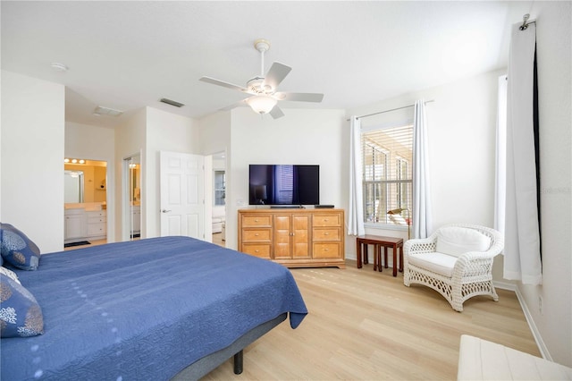 bedroom featuring connected bathroom, ceiling fan, and light wood-type flooring