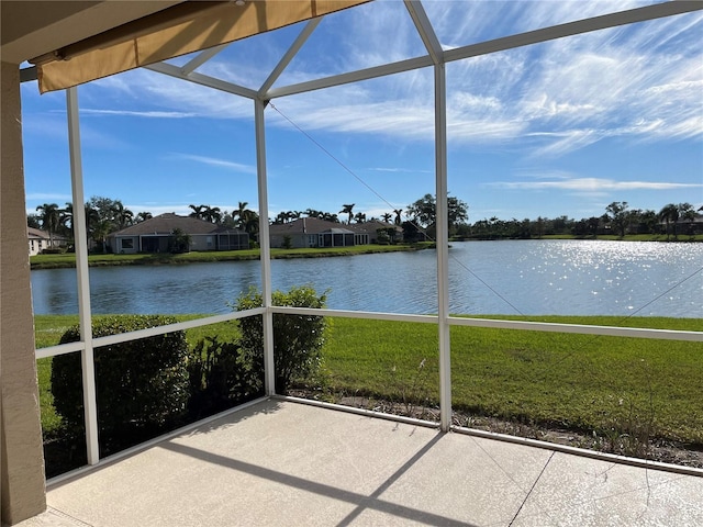 unfurnished sunroom featuring a water view