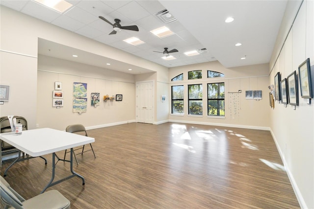 office area with ceiling fan, wood-type flooring, and a paneled ceiling