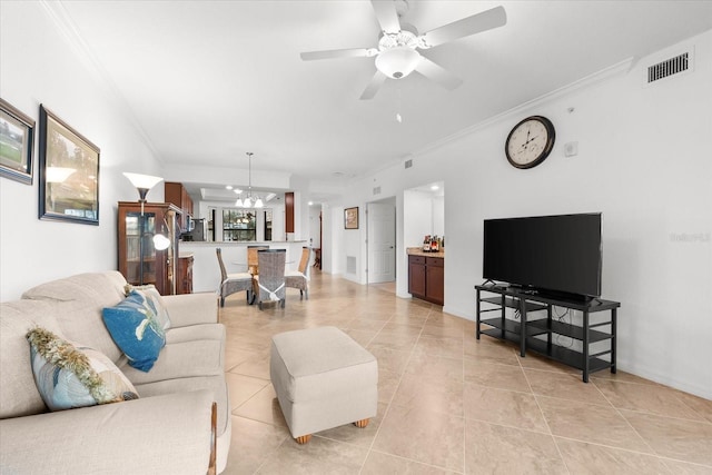 living room featuring ceiling fan with notable chandelier, crown molding, and light tile patterned flooring