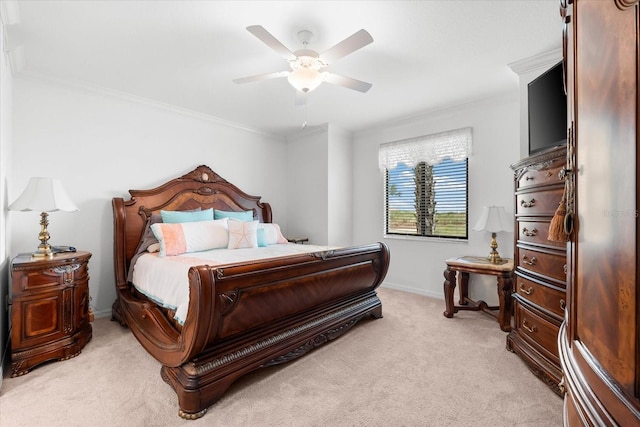 carpeted bedroom featuring ceiling fan and crown molding