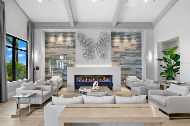 living room featuring beam ceiling and light wood-type flooring