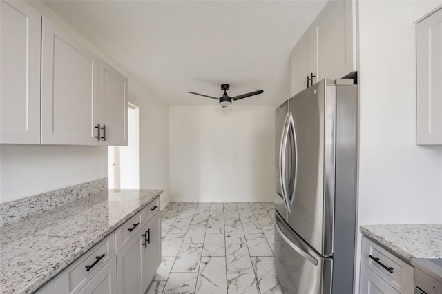 kitchen with white cabinetry and stainless steel refrigerator