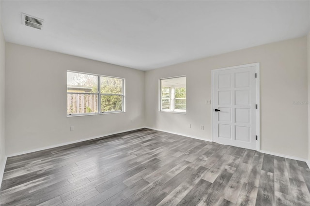 unfurnished room featuring hardwood / wood-style flooring