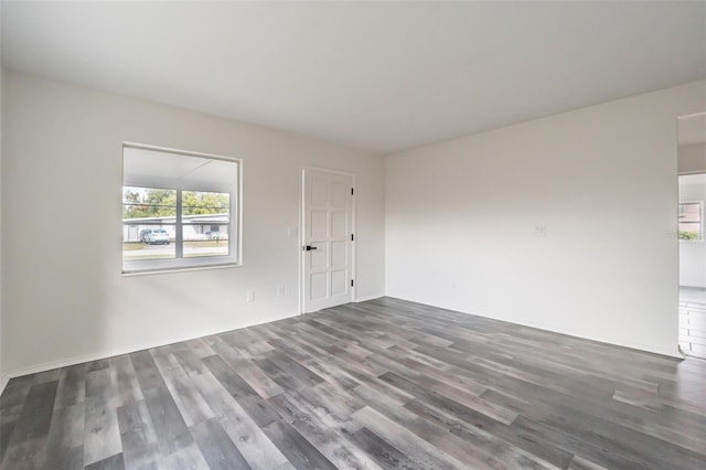 empty room with dark hardwood / wood-style floors