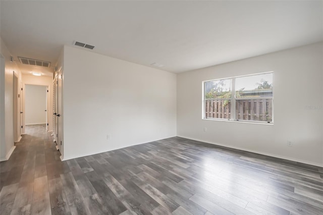 empty room featuring dark hardwood / wood-style flooring