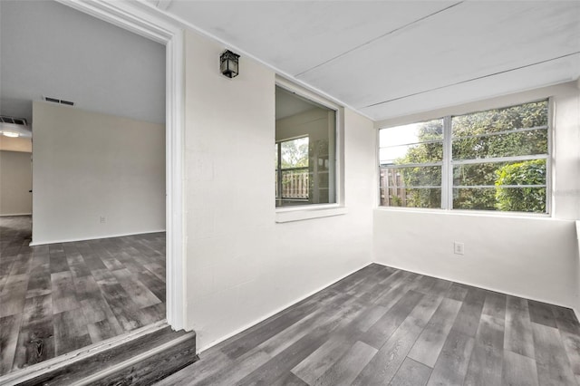 empty room with dark wood-type flooring