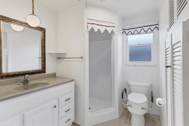 bathroom featuring vanity, toilet, and walk in shower