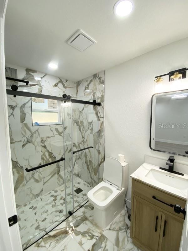 bathroom with vanity, toilet, and walk in shower