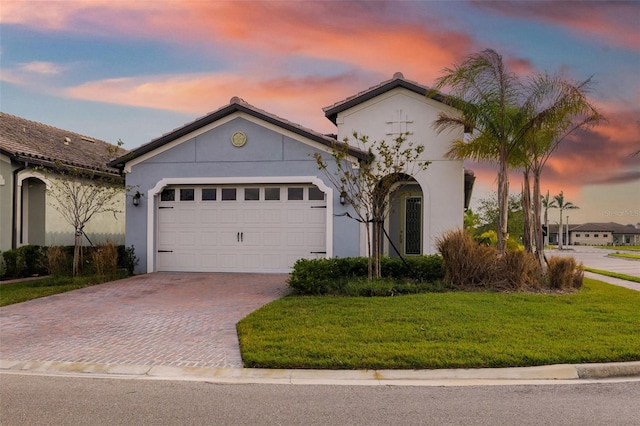 view of front of home with a lawn and a garage