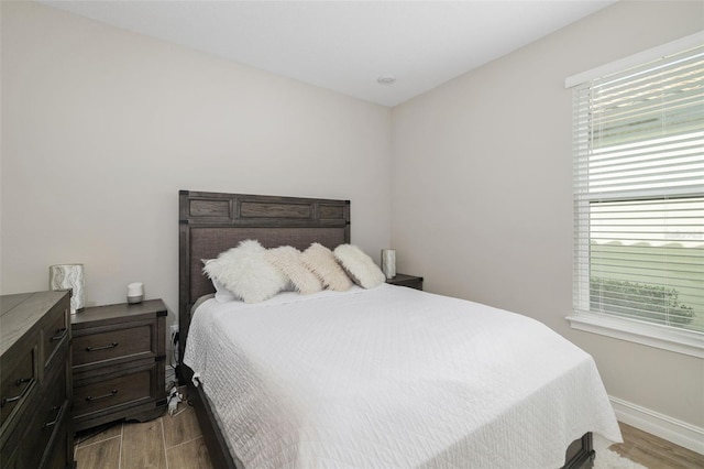 bedroom featuring light wood-type flooring and multiple windows