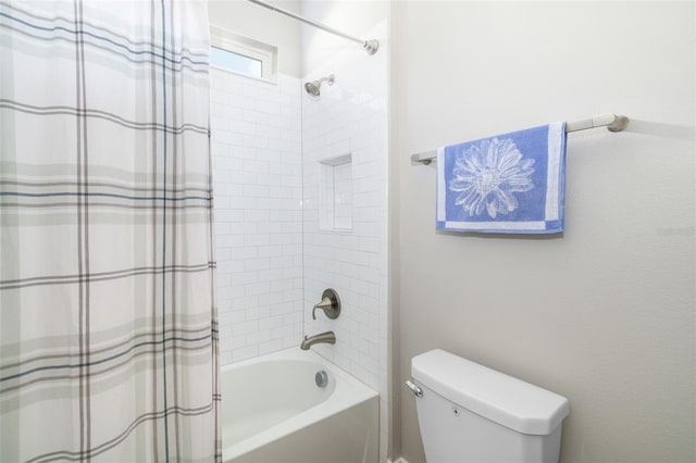 bathroom with shower / tub combo and toilet