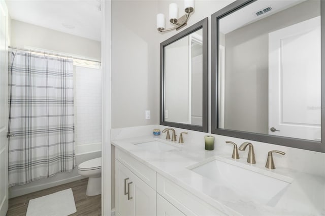 full bathroom with vanity, toilet, wood-type flooring, and shower / bath combo with shower curtain