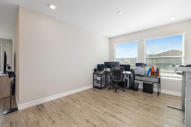 office with light wood-type flooring