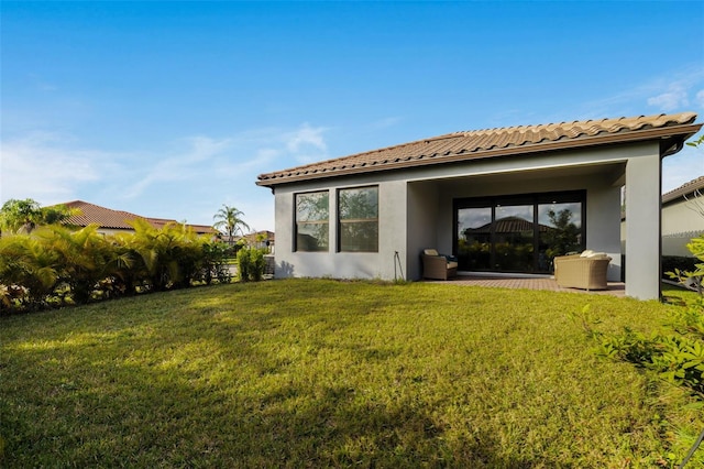 back of house featuring a yard