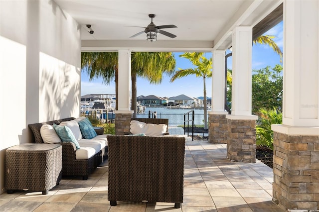 view of patio / terrace with ceiling fan, a water view, and an outdoor hangout area