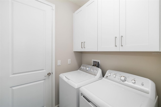 laundry area featuring cabinets and washing machine and dryer