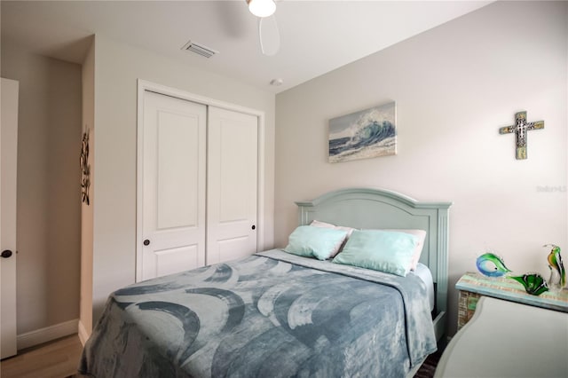 bedroom with ceiling fan, hardwood / wood-style floors, and a closet