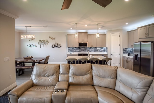 living room featuring crown molding and ceiling fan