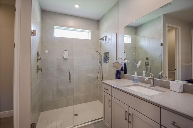 bathroom with vanity, a shower with door, and toilet