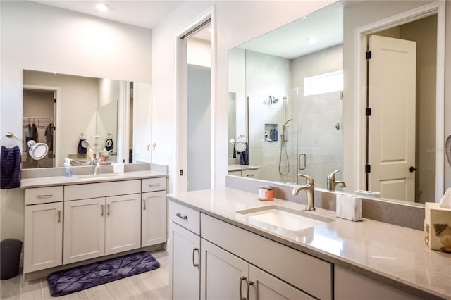 bathroom with walk in shower and vanity