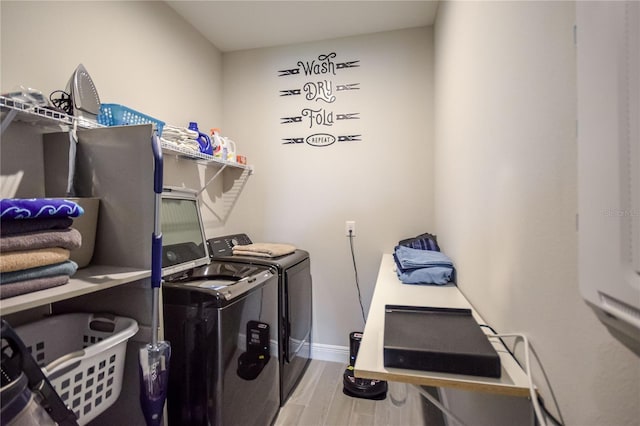 washroom featuring hardwood / wood-style floors and independent washer and dryer