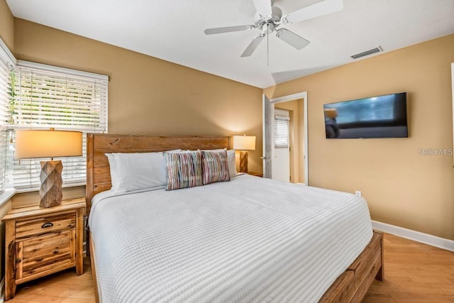 bedroom with ceiling fan and light hardwood / wood-style flooring