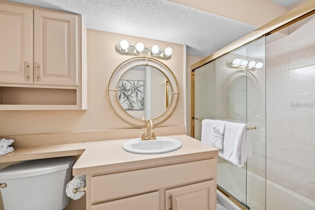 full bathroom with toilet, vanity, a textured ceiling, and combined bath / shower with glass door