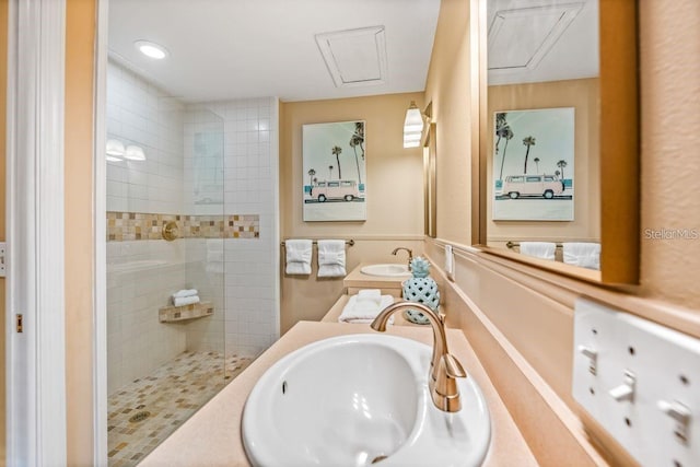 bathroom featuring vanity and tiled shower