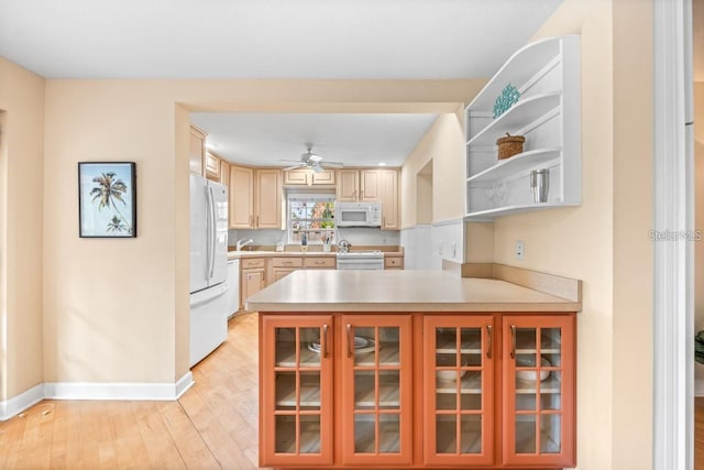 kitchen with kitchen peninsula, light brown cabinetry, white appliances, ceiling fan, and light hardwood / wood-style flooring