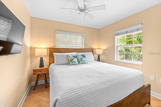 bedroom with ceiling fan and light hardwood / wood-style flooring