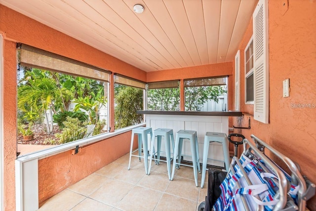 sunroom featuring wood ceiling