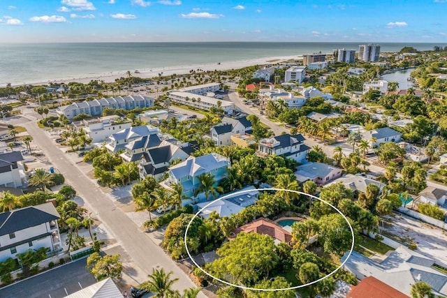 drone / aerial view with a water view and a view of the beach