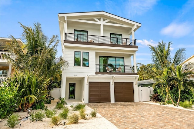 view of front of house featuring a balcony and a garage