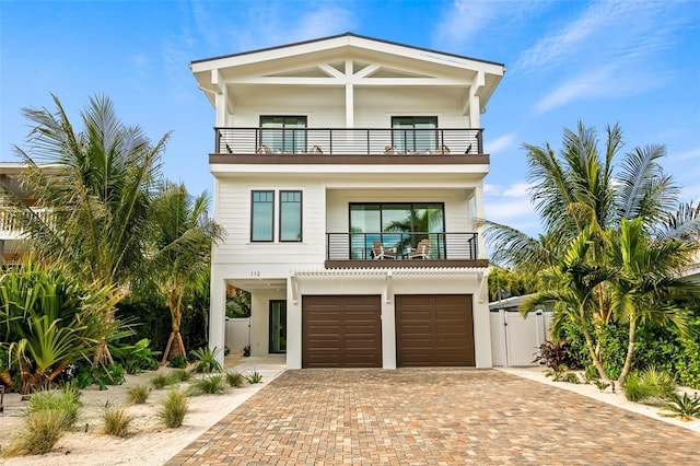 beach home with a garage and a balcony