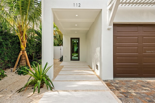 doorway to property with a garage