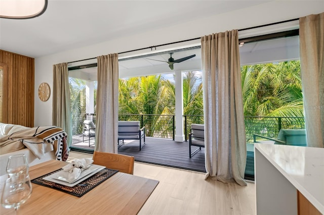 doorway to outside featuring ceiling fan and light hardwood / wood-style flooring