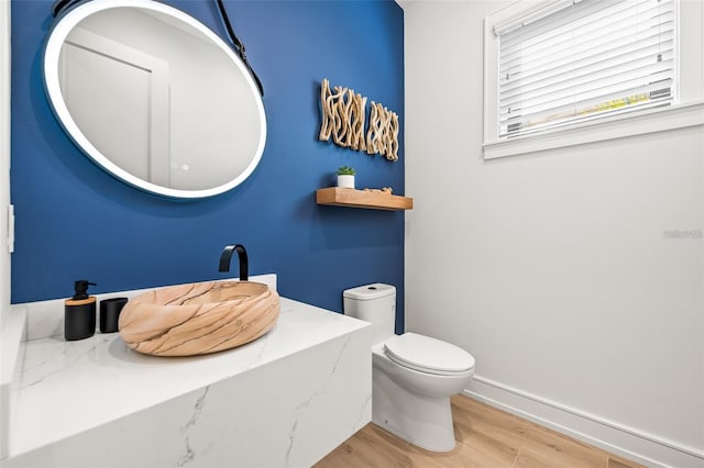 bathroom featuring hardwood / wood-style floors and toilet