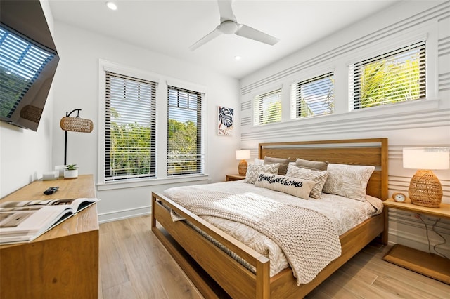 bedroom featuring ceiling fan and light hardwood / wood-style flooring