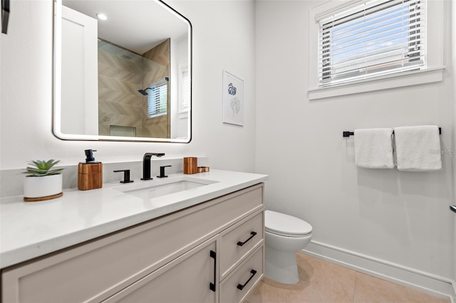 bathroom with a shower, tile patterned flooring, vanity, and toilet