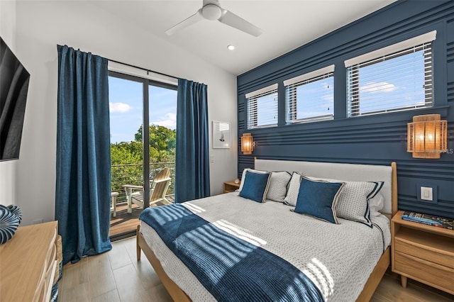 bedroom with access to exterior, hardwood / wood-style flooring, and ceiling fan