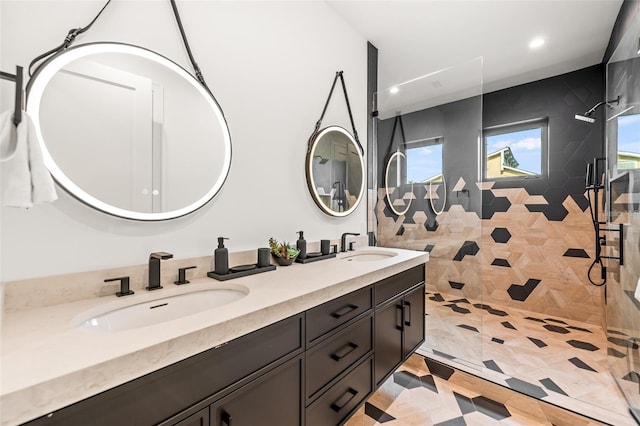 bathroom with a tile shower, tile patterned floors, and vanity